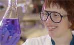 Photograph of a scientist holding a flask